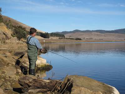 An angler fishing the northwestern side of Craigbourne Dam.