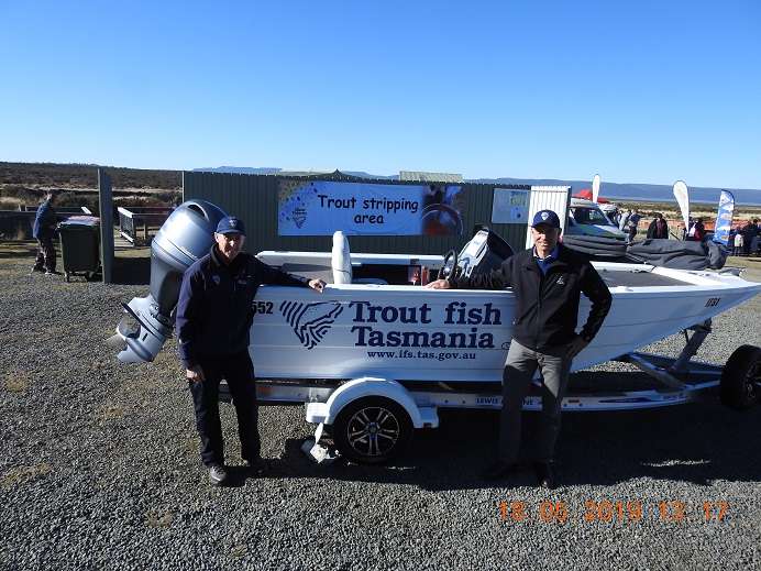 The Honourable Guy Barnett (Minister for Primary Industries and Water) standing with John Diggle (Director of Inland Fisheries) at the 2019 Liawenee Trout Weekend beside a boat