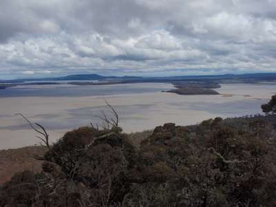 A landscape photos looking out over Lake Sorelll. There are rumbling clouds in the sky and the colours and grey and blue