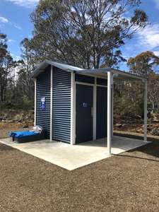 The toilet at on the Arthurs Lake Road opposite the store. A free standing building made of dark blue colour bond.